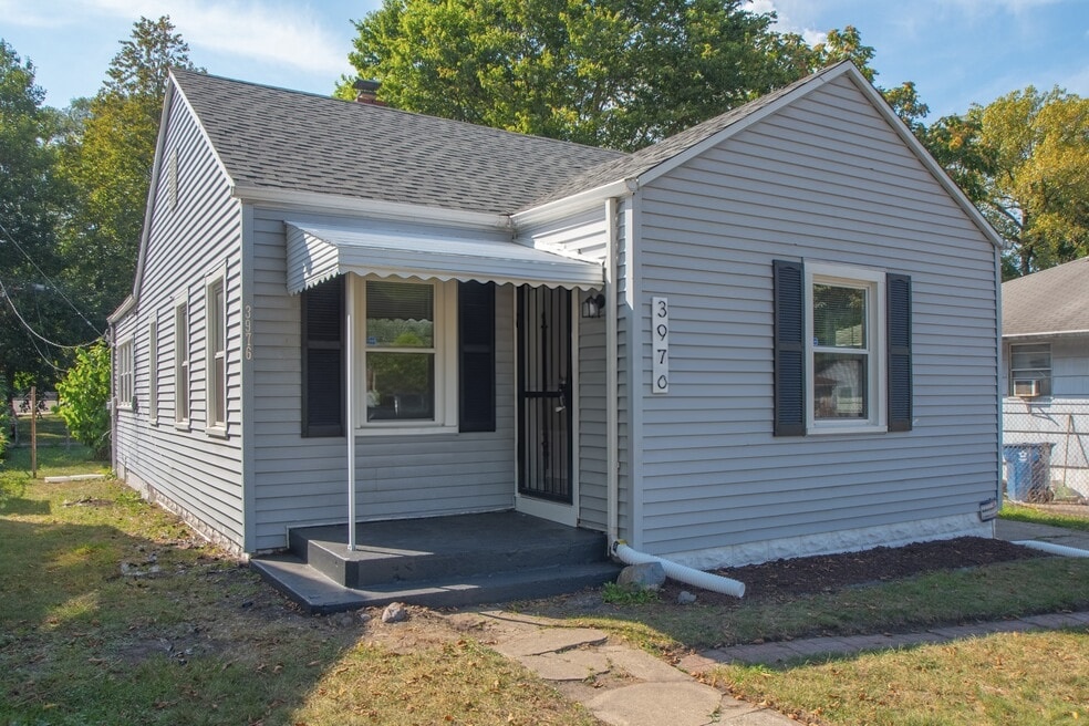 Front exterior of the light blue-gray ranch home