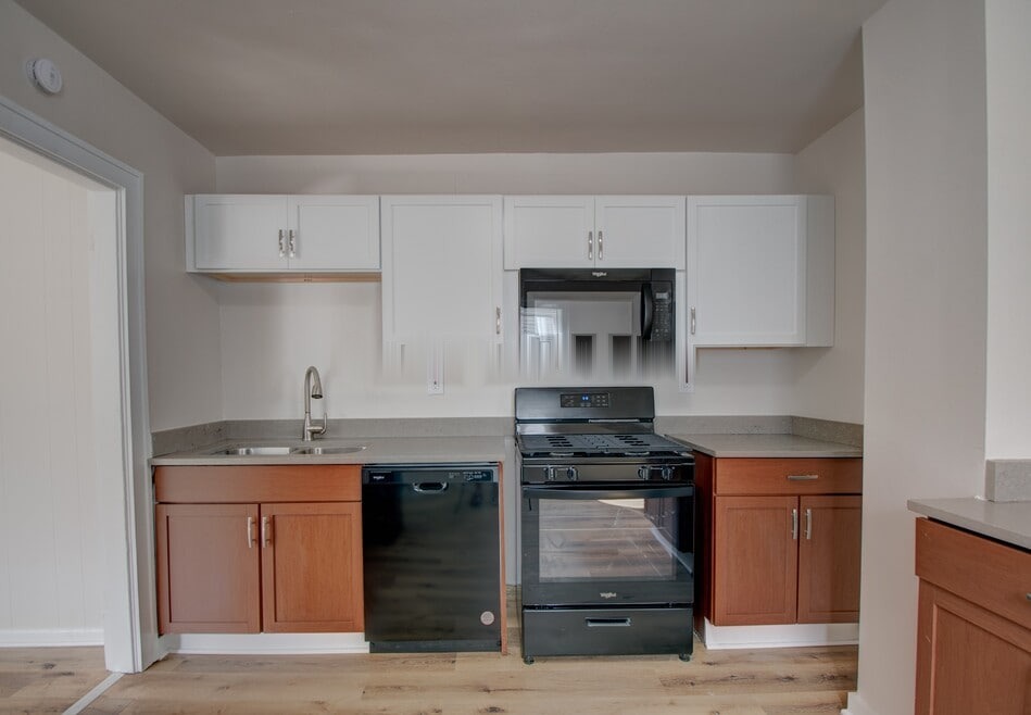 Updated eat-in kitchen with warm wood cabinetry and stainless appliances